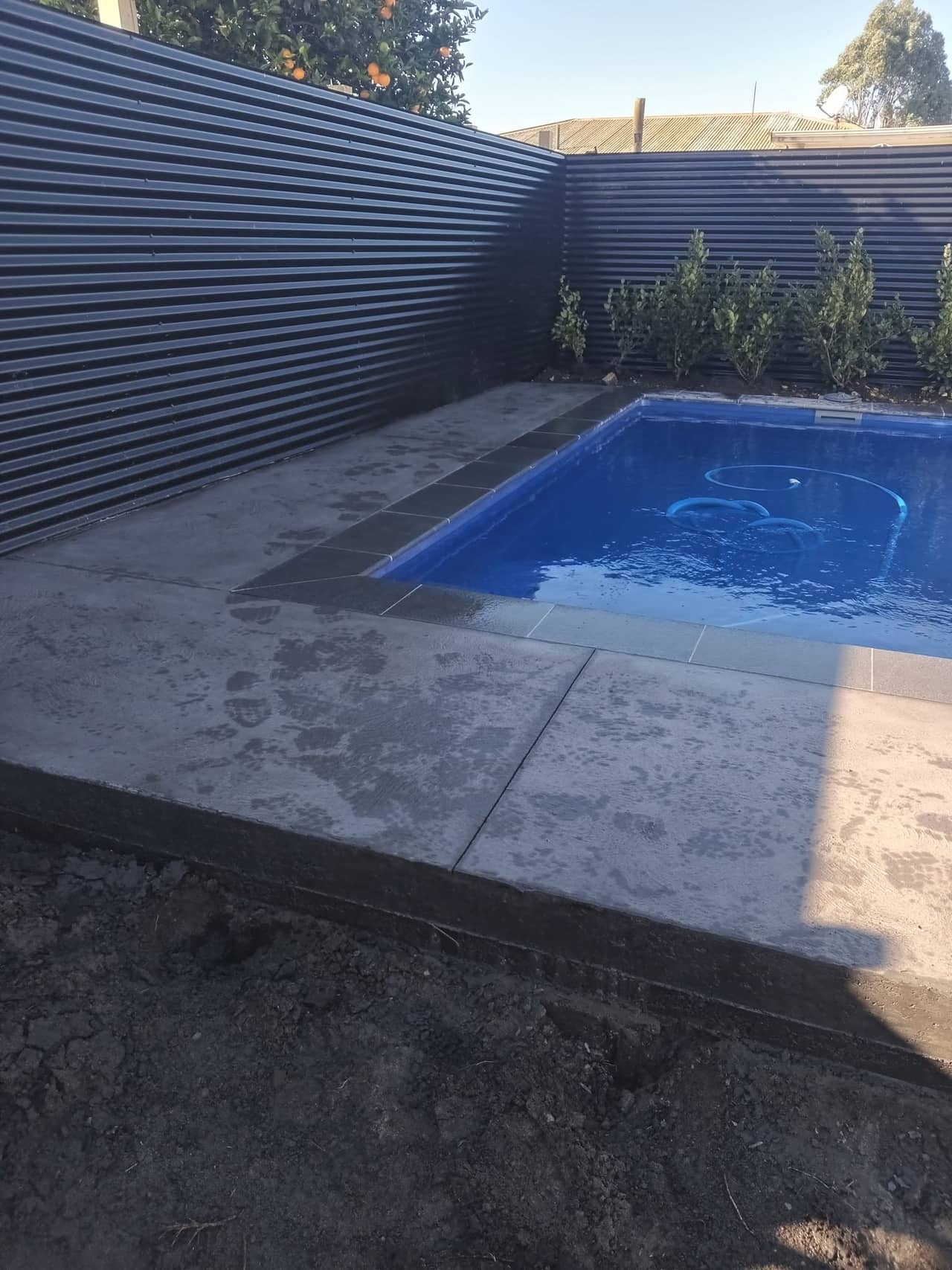 Charcoal concrete pool surround detail with dark coping, Gisborne
